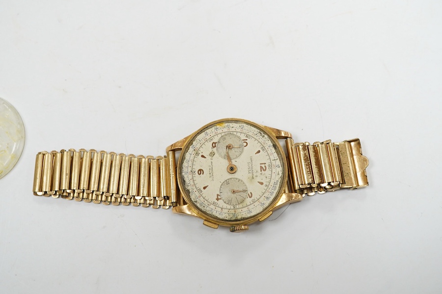 A gentleman's yellow metal Swiss chronograph manual wind wrist watch (lacking back cover), on a gold plated strap. Condition - poor.